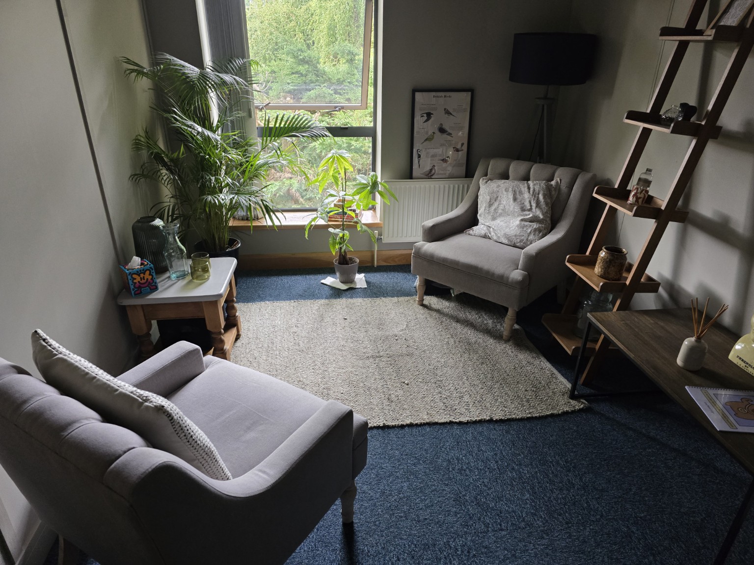 Two armchairs in Dr Helen Blake’s therapy room in York, with plants, a rug and a window